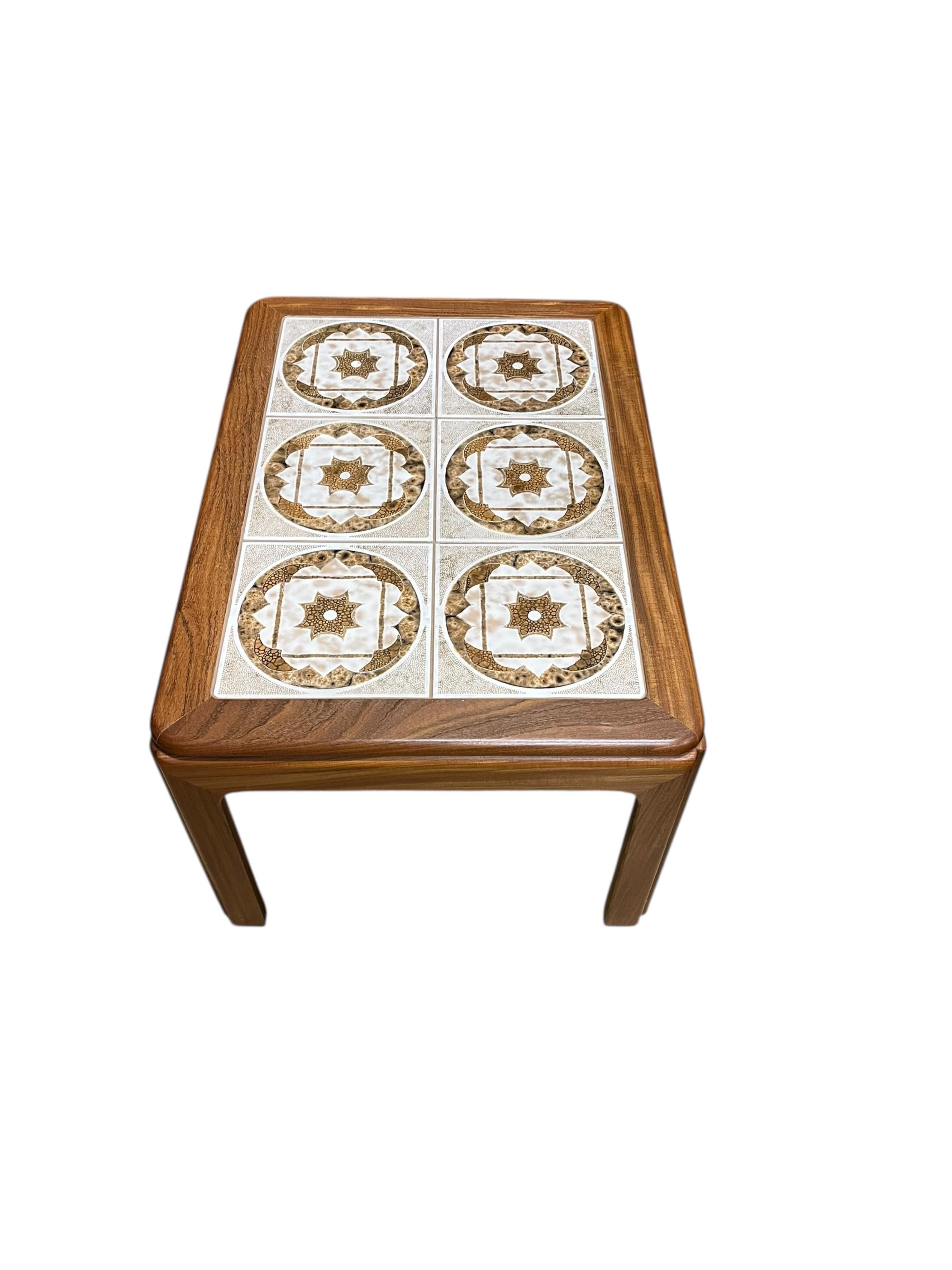 A mid century G Plan tile top teak coffee table and two matching occasional tables, larger width 134cm, depth 74cm, height 46cm